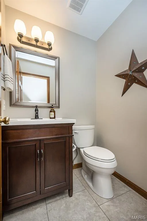 Dark wood-finish vanity with a white countertop and rectangular sink — 1551 Country Bend Drive, St Charles, MO 63303