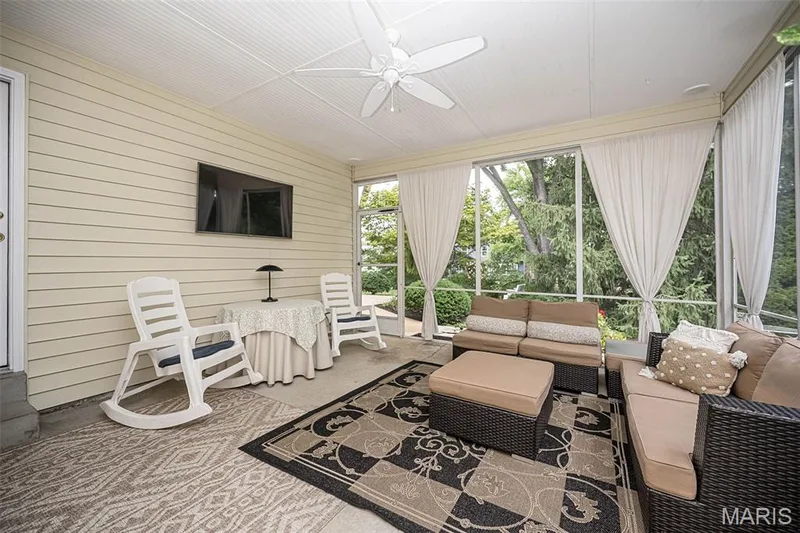 Screened porch featuring a ceiling fan, horizontal siding, and large screened panels — 1551 Country Bend Drive, St Charles, MO 63303