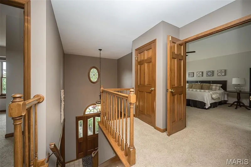 Two-story entry with wood-finish double doors and decorative glass — 1551 Country Bend Drive, St Charles, MO 63303