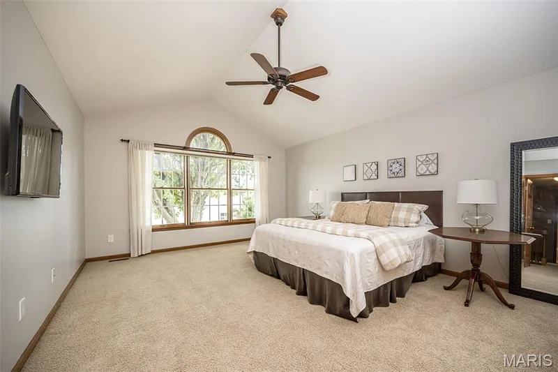 Vaulted ceiling, ceiling fan, arched transom window, large window, wall-mounted television — 1551 Country Bend Drive, St Charles, MO 63303