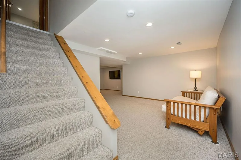Carpeted staircase with wood handrail — 1551 Country Bend Drive, St Charles, MO 63303