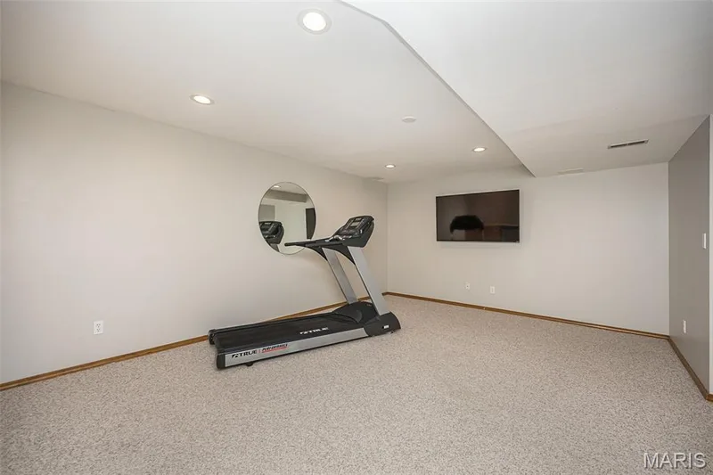 Carpeted flooring, recessed lighting, and a wall-mounted television — 1551 Country Bend Drive, St Charles, MO 63303