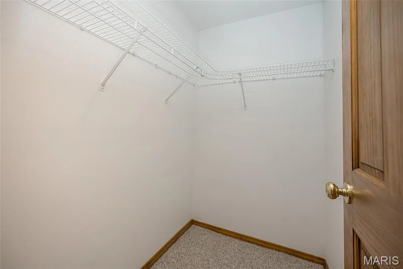Walk-in closet with wire shelving and light-colored carpeting — 1551 Country Bend Drive, St Charles, MO 63303