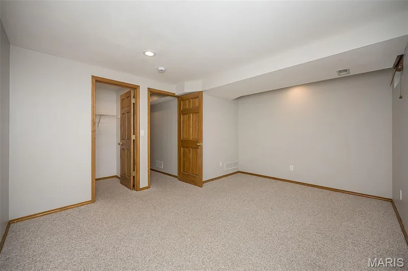 Recessed lighting illuminates neutral-toned walls and plush carpeting — 1551 Country Bend Drive, St Charles, MO 63303