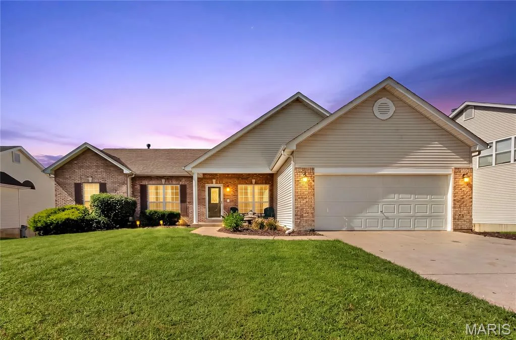 Brick and siding exterior with a gabled roofline and attached two-car garage — 934 Annabrook Park Drive, O'Fallon, MO 63366