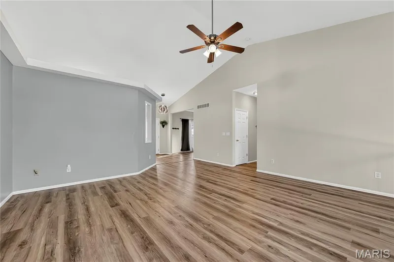 Vaulted ceiling featuring a ceiling fan with integrated lighting, wood-finish flooring, and recessed lighting — 934 Annabrook Park Drive, O'Fallon, MO 63366