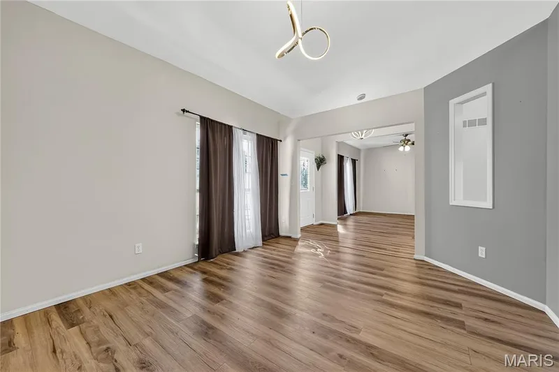 Wood-finish flooring throughout, light neutral wall paint, and a modern ceiling fixture — 934 Annabrook Park Drive, O'Fallon, MO 63366