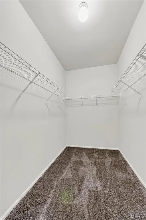 Recessed lighting illuminates the space, featuring white wire shelving for organized storage and a neutral-toned carpet — 934 Annabrook Park Drive, O'Fallon, MO 63366