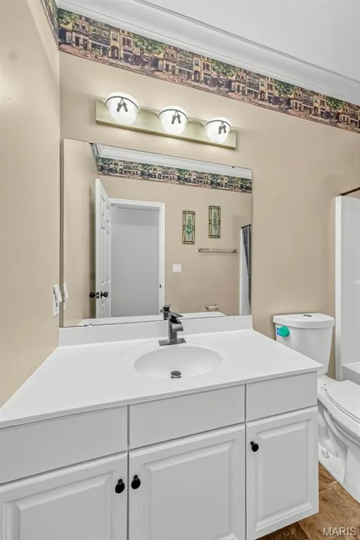 Vanity with white cabinetry, integrated sink, and dark hardware — 934 Annabrook Park Drive, O'Fallon, MO 63366