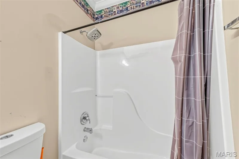 Bathtub and shower combination with chrome fixtures and white surround — 934 Annabrook Park Drive, O'Fallon, MO 63366