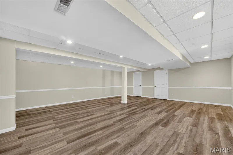 Spacious room featuring wood-finish flooring, recessed lighting, and a drop ceiling — 934 Annabrook Park Drive, O'Fallon, MO 63366