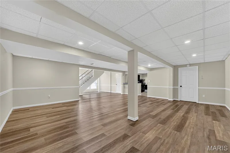 Spacious finished lower level featuring wood-finish flooring, recessed lighting, and a neutral color palette — 934 Annabrook Park Drive, O'Fallon, MO 63366