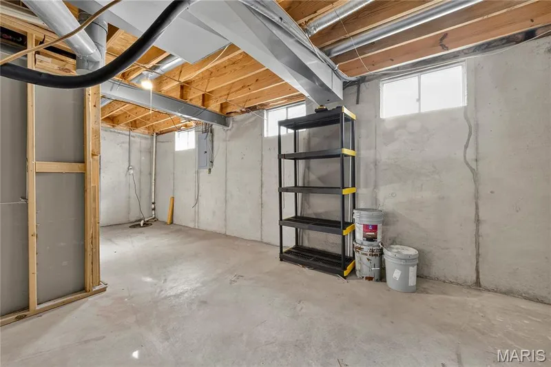Unfinished basement with concrete flooring, exposed ceiling joists, and multiple windows — 934 Annabrook Park Drive, O'Fallon, MO 63366