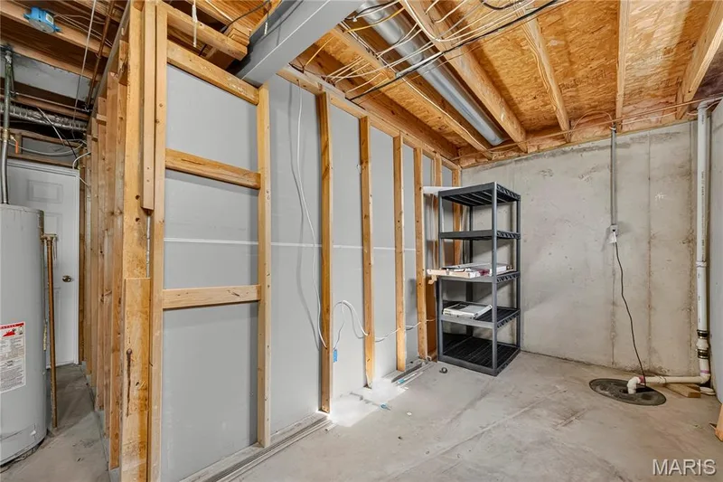 Unfinished basement with concrete flooring and exposed wood framing — 934 Annabrook Park Drive, O'Fallon, MO 63366