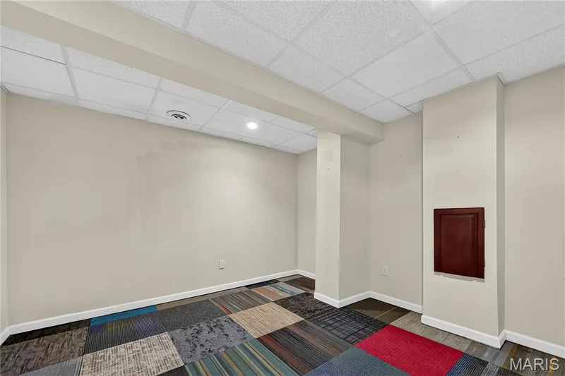 Recessed lighting, drop ceiling, neutral wall paint, multi-colored carpet tiles, and white trim — 934 Annabrook Park Drive, O'Fallon, MO 63366