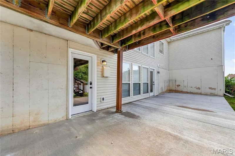 Covered concrete patio with direct access to interior spaces and a full-light exterior door — 934 Annabrook Park Drive, O'Fallon, MO 63366