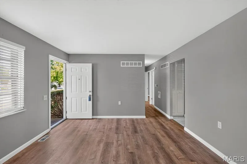 Living room with vinyl plank flooring and fresh paint. — 2428 Golfway Drive, St Charles, MO 63301