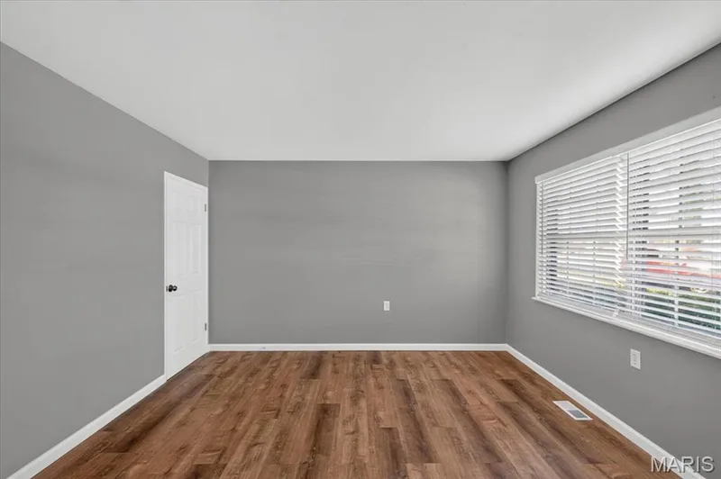 The living room comes w/faux wood blinds and a coat closet. — 2428 Golfway Drive, St Charles, MO 63301