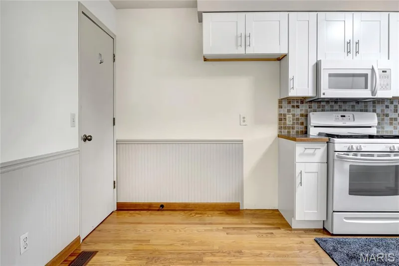 The eating area and kitchen have hardwood floors. — 1401 Tamarack Drive, St Charles, MO 63301
