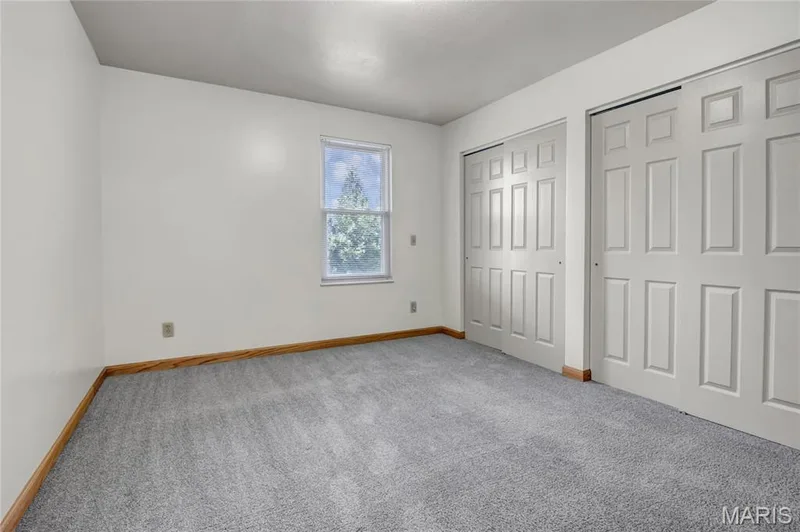 The primary bedroom features double closets. — 1401 Tamarack Drive, St Charles, MO 63301