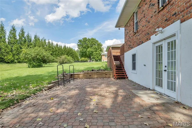 Back patio that has steps leading to the deck — 1401 Tamarack Drive, St Charles, MO 63301