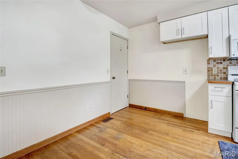 The eating area and kitchen have hardwood floors. — 1401 Tamarack Drive, St Charles, MO 63301