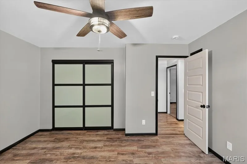Primary bedroom very cool and trendy sliding closet doors. — 1688 Knightwood Lane, O'Fallon, MO 63366