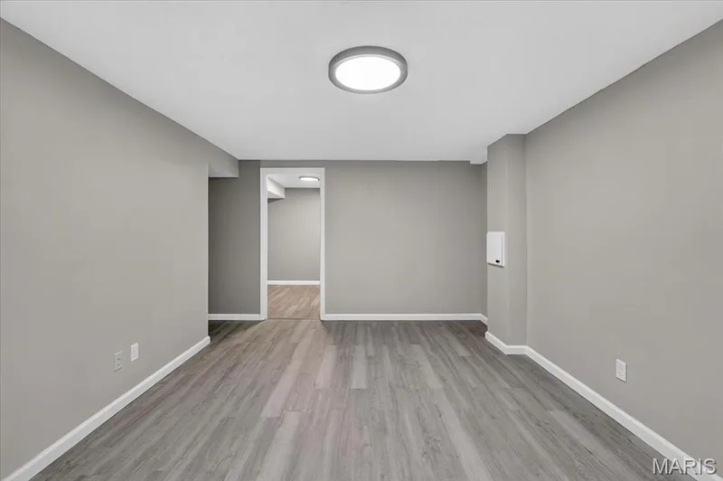 Finished lower level with LVP flooring and newer paint. — 1688 Knightwood Lane, O'Fallon, MO 63366