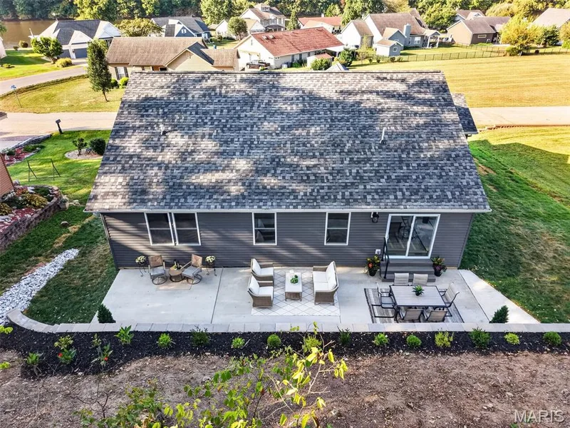 An expansive backyard patio offers multiple areas for dining, conversation and entertaining. — 11075 Village Drive, Foristell, MO 63348