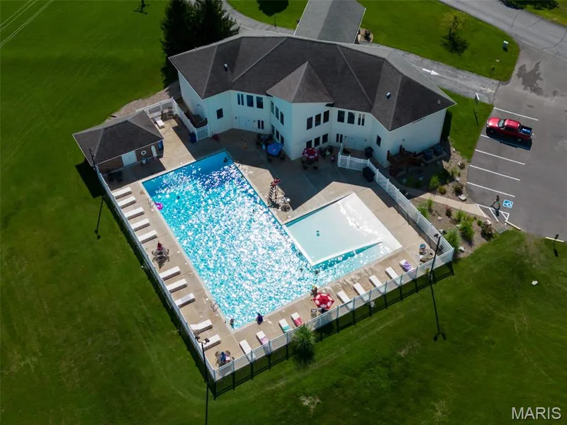 The community pool features a walk-in entry and separate shallow area for summer enjoyment. — 11075 Village Drive, Foristell, MO 63348