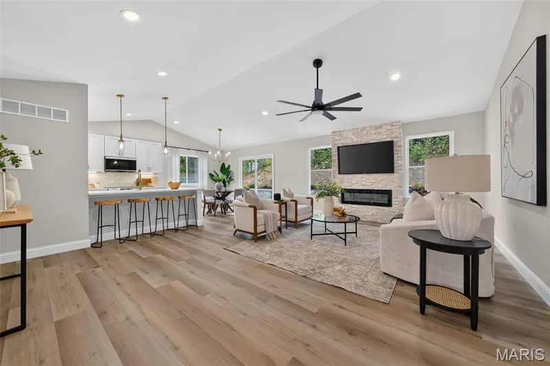 The open-concept design seamlessly connects the vaulted great room, kitchen and dining area. — 11075 Village Drive, Foristell, MO 63348