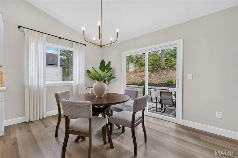The dining area opens directly to the expansive backyard patio. — 11075 Village Drive, Foristell, MO 63348