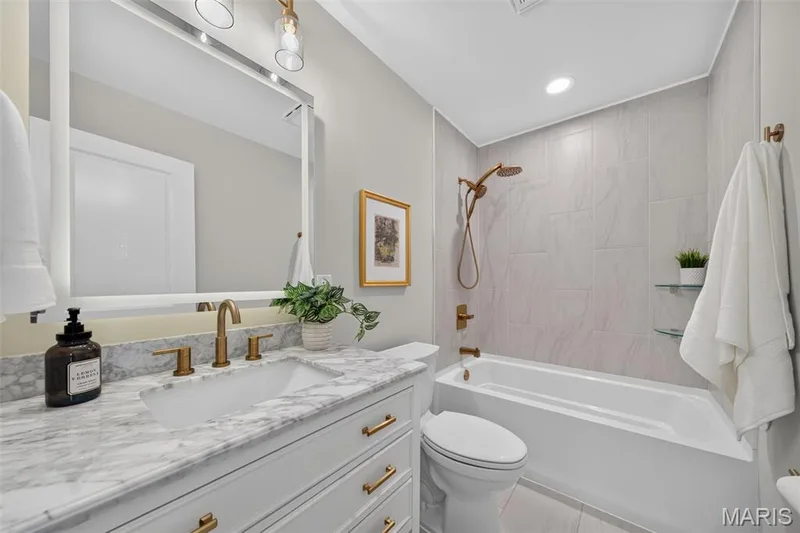 The full hall bath continues the home’s cohesive designer finishes. — 11075 Village Drive, Foristell, MO 63348