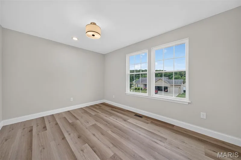 A bright, spacious secondary bedroom offers generous natural light. — 11075 Village Drive, Foristell, MO 63348