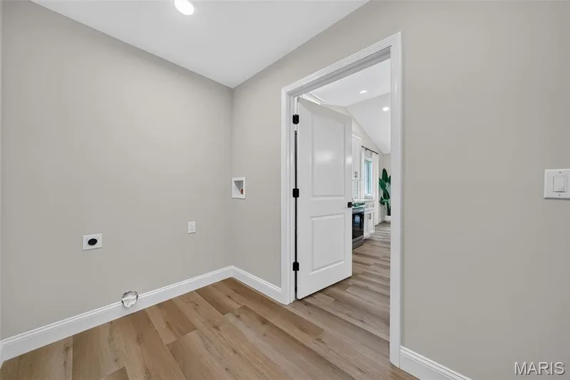 Conveniently located between the garage and kitchen, the laundry and drop zone includes motion-activated lighting. — 11075 Village Drive, Foristell, MO 63348