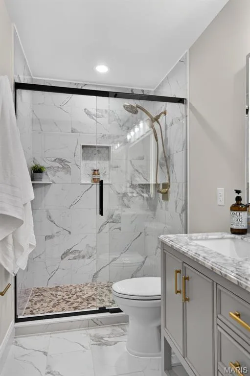 Glass-enclosed shower with a pebble floor and recessed niche — 11075 Village Drive, Foristell, MO 63348