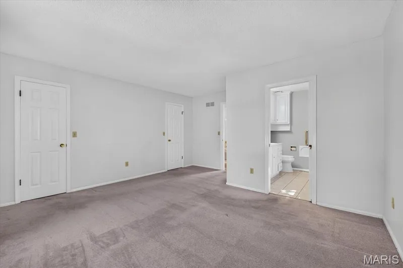Primary bedroom offers dual closets and en suite bath — 20 Ardennais Road, St Peters, MO 63376