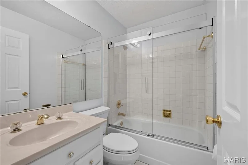 Hall Bath- White vanity with stone-finish countertop and integrated sink — 20 Ardennais Road, St Peters, MO 63376
