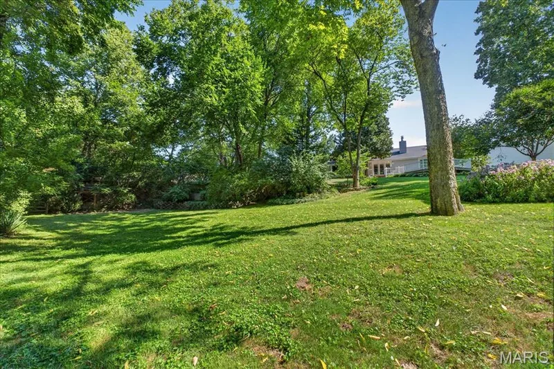 Expansive lawn area with mature trees and established perimeter landscaping — 20 Ardennais Road, St Peters, MO 63376