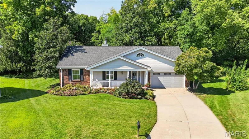 Ranch-style residence featuring a gray shingle roof, light-colored siding, and brick accents — 20 Ardennais Road, St Peters, MO 63376