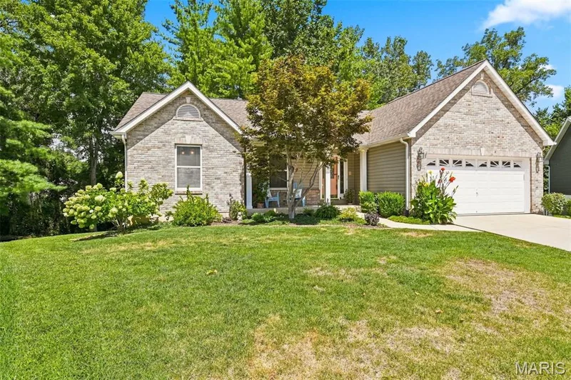 Stone façade and siding exterior with an attached garage — 55 Treeshade Court, St Peters, MO 63376