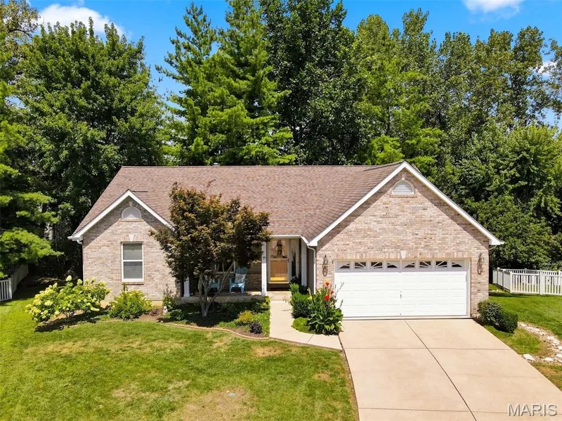 Brick exterior with gabled roofline and attached garage — 55 Treeshade Court, St Peters, MO 63376