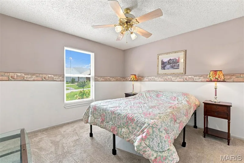 Textured ceiling, wall-mounted ceiling fan, and carpeted flooring — 55 Treeshade Court, St Peters, MO 63376