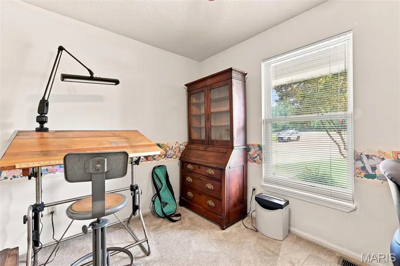 Wall-to-wall carpeting with a neutral finish, a single window with blinds, and white walls — 55 Treeshade Court, St Peters, MO 63376