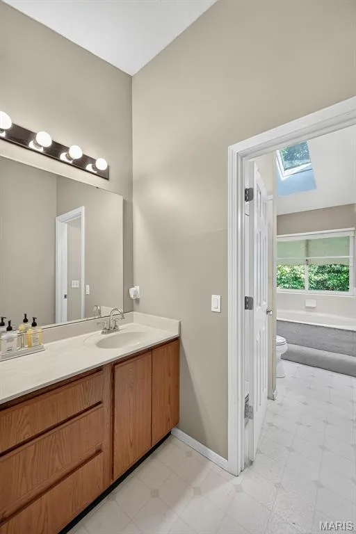 Upper bathroom leading into shower, tub and toilet area — 1 Rue De Paix #6, Lake St. Louis, MO 63367