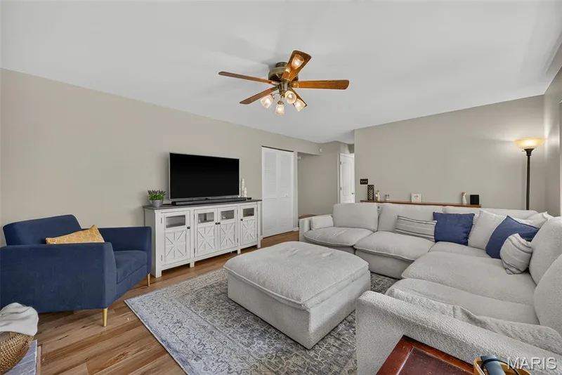 Recessed ceiling fan with light fixture, wood-finish flooring, built-in shelving, white paneled doors, and neutral wall tones — 10 Docs Ct., St Charles, MO 63303