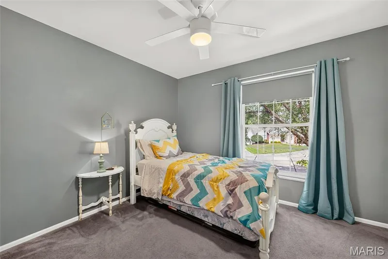 Wall-to-wall carpeting, window with exterior views, and a ceiling fan with integrated lighting — 10 Docs Ct., St Charles, MO 63303