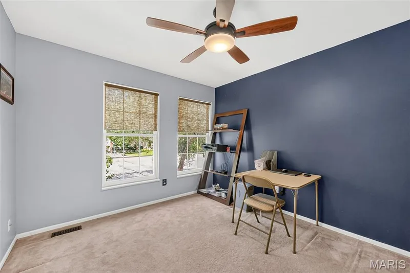 Two windows with blinds, ceiling fan with light fixture, and carpeted flooring — 10 Docs Ct., St Charles, MO 63303