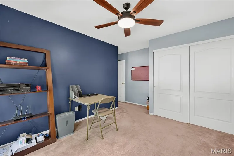 Built-in ceiling fan with integrated lighting, two-panel sliding closet doors, and wood-finish open shelving — 10 Docs Ct., St Charles, MO 63303