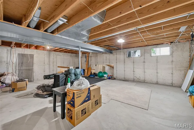 Exposed wood beam ceiling with concrete flooring and foundation walls — 10 Docs Ct., St Charles, MO 63303
